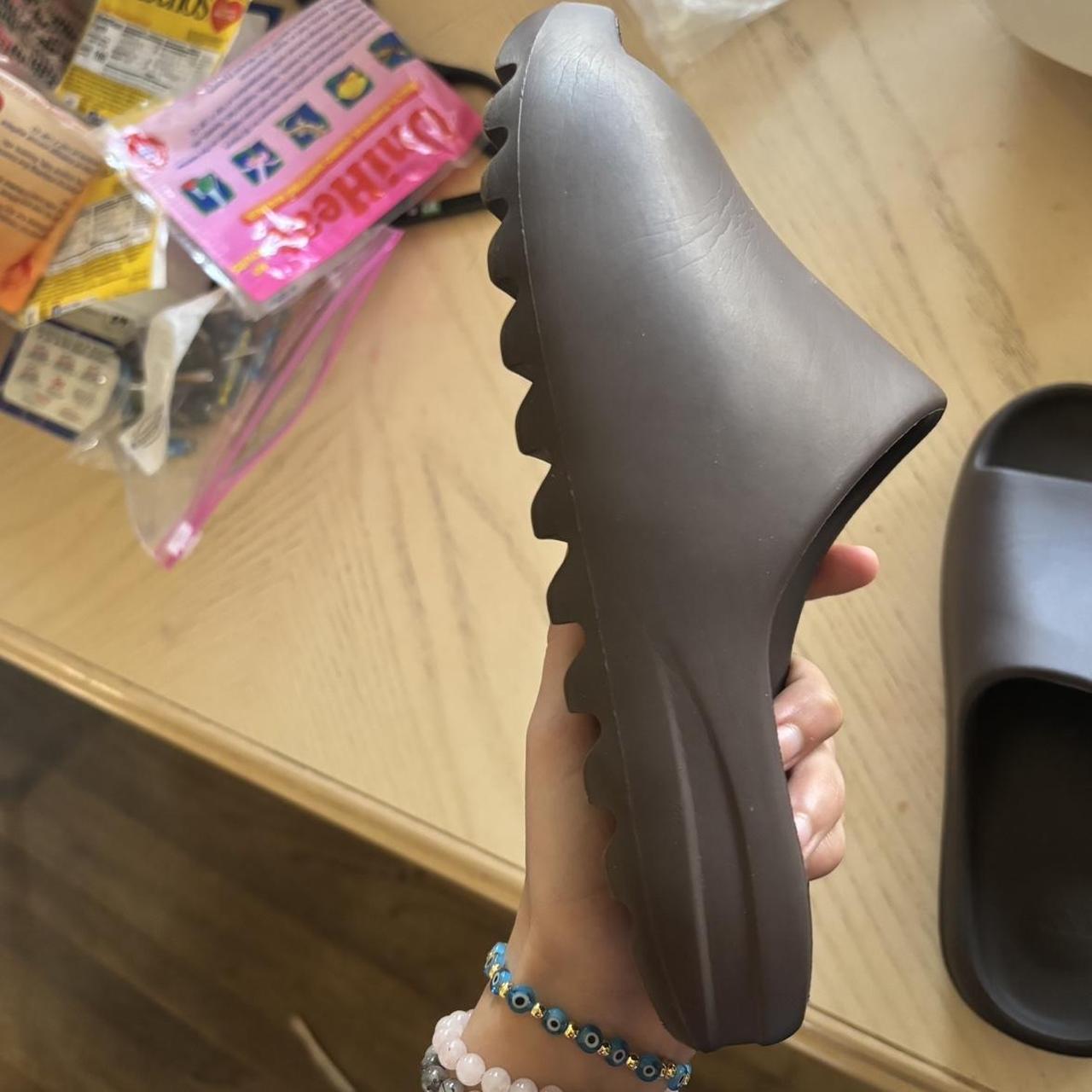 brown yeezy slides on feet