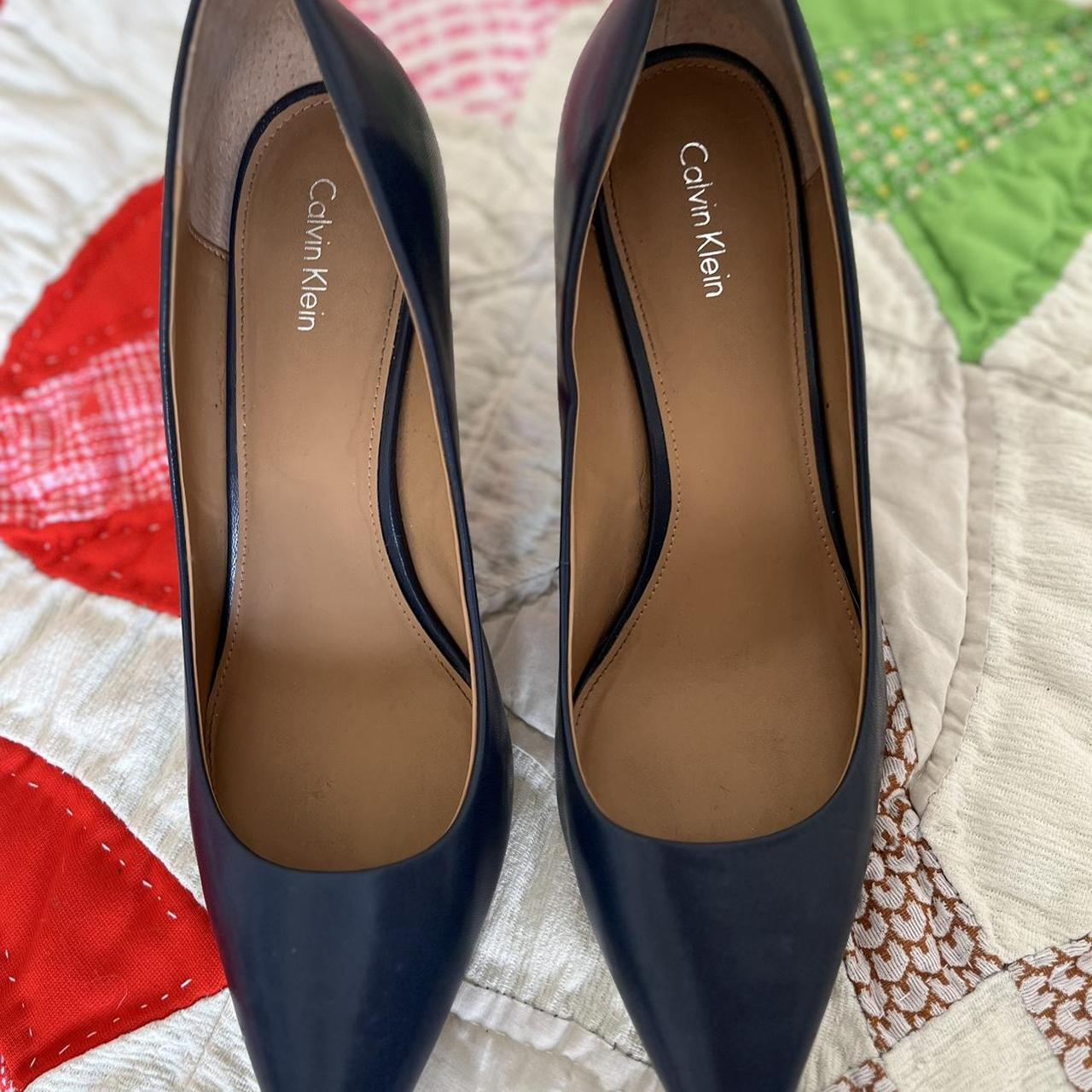 Calvin Klein navy heels lightly worn. small scratch