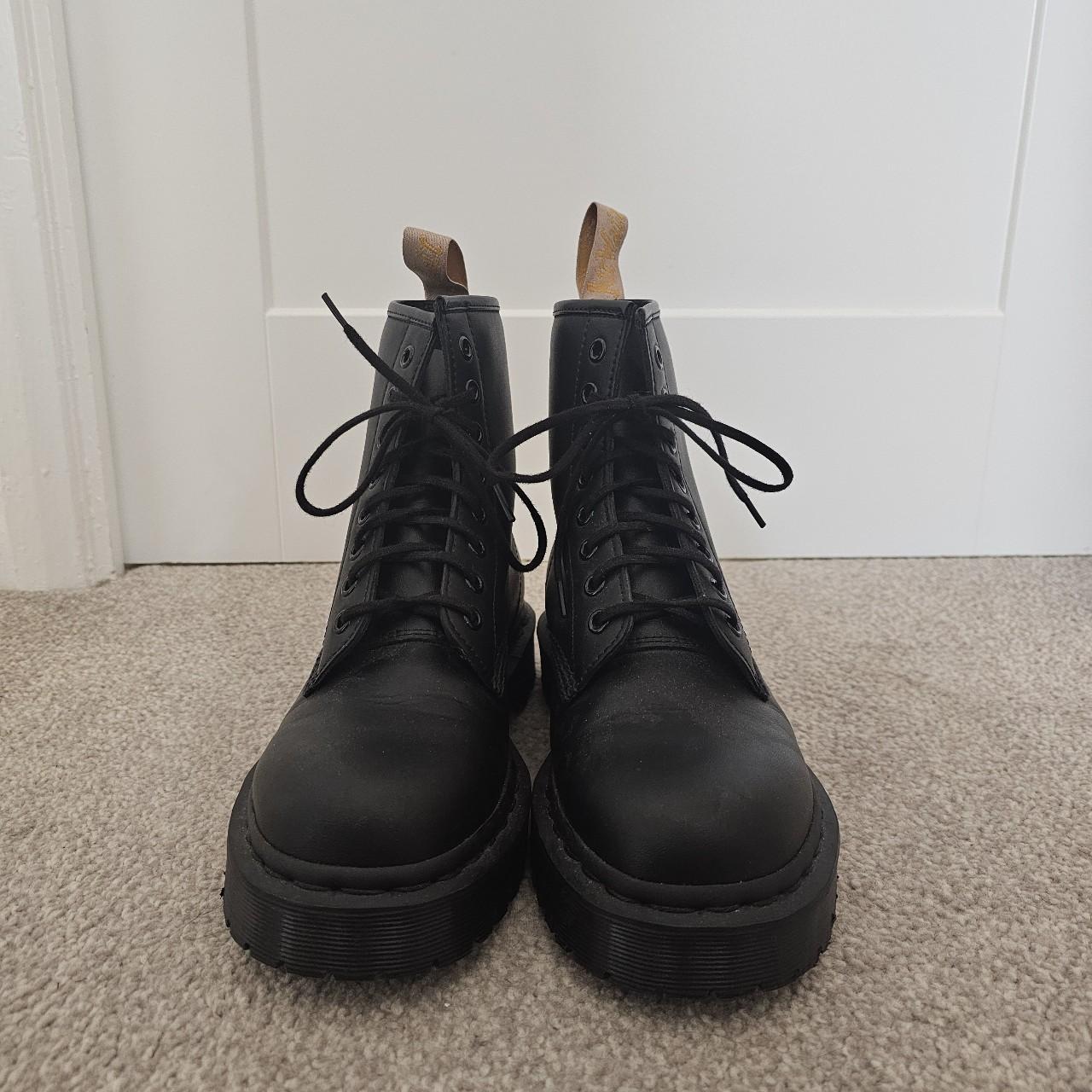 Black boots with yellow tag best sale