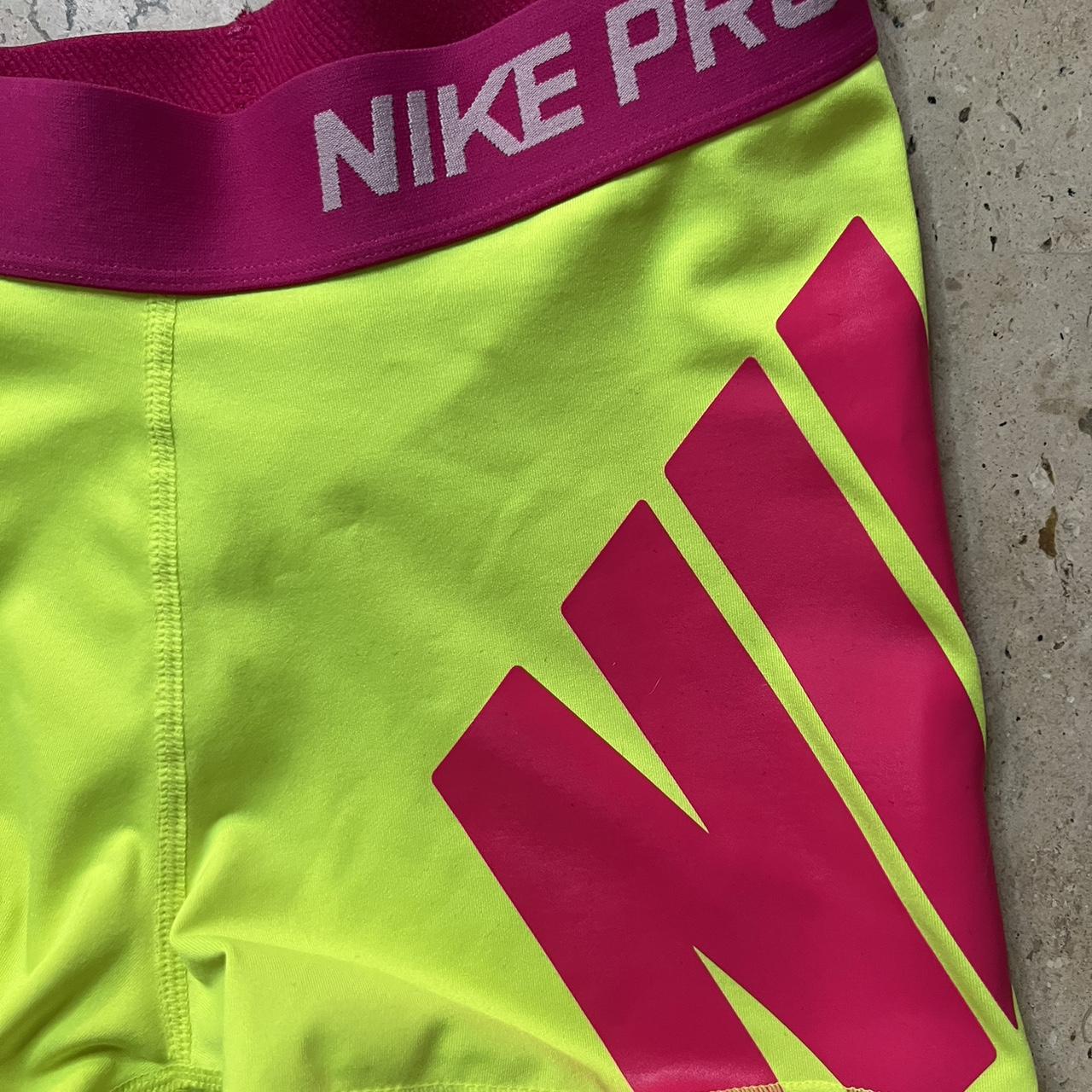 green and pink nike shorts