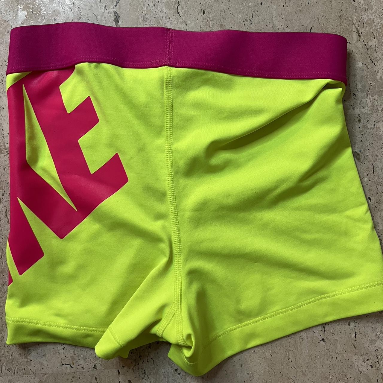 green and pink nike shorts