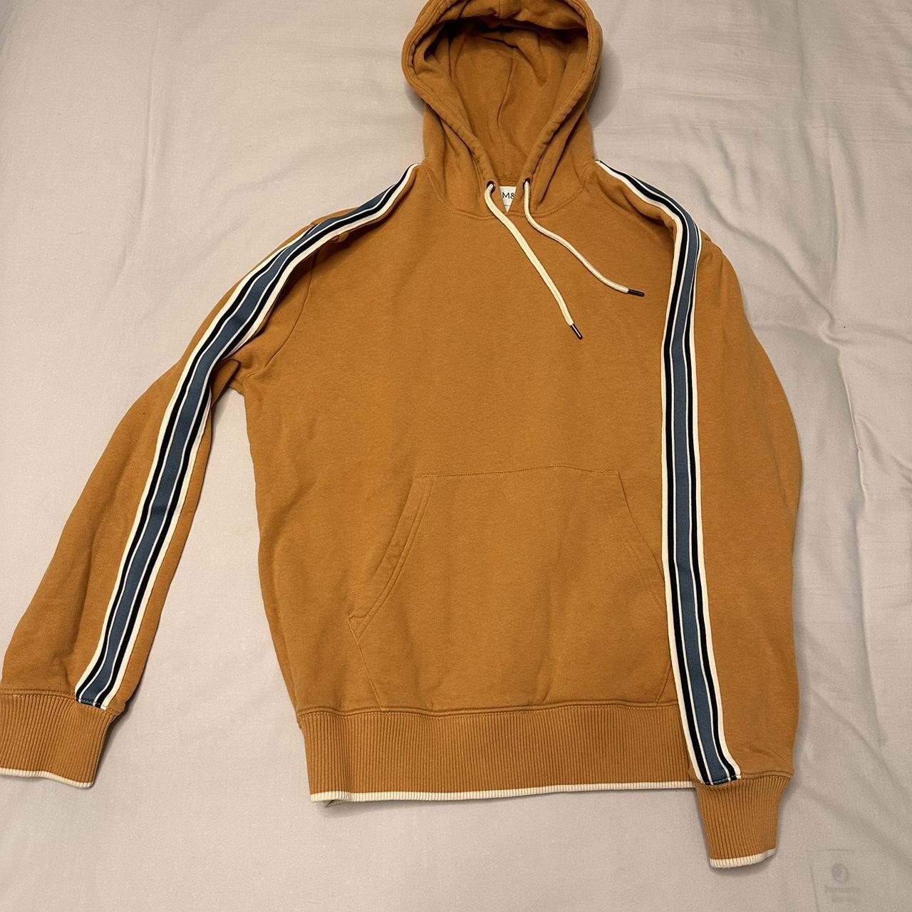 Tan yellow hoodie with a blue and white stripe on