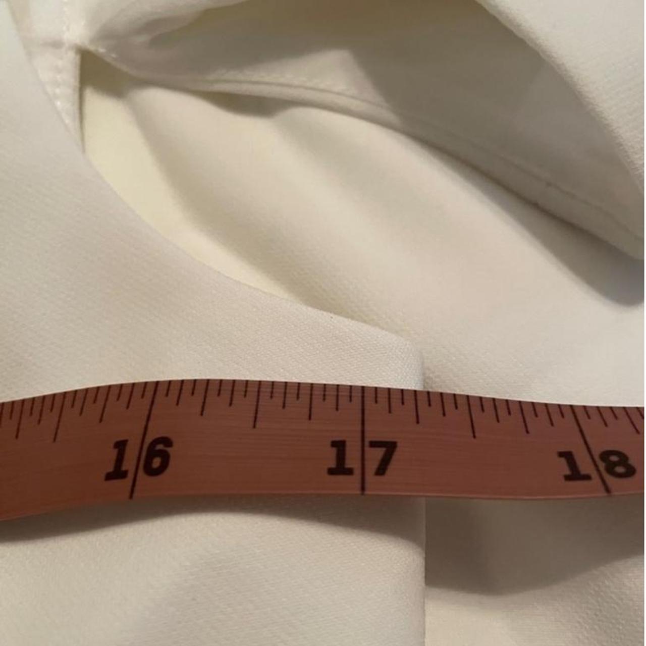 This is a white BCBGMAXAZRIA jumpsuit with a v-neck, | Depop