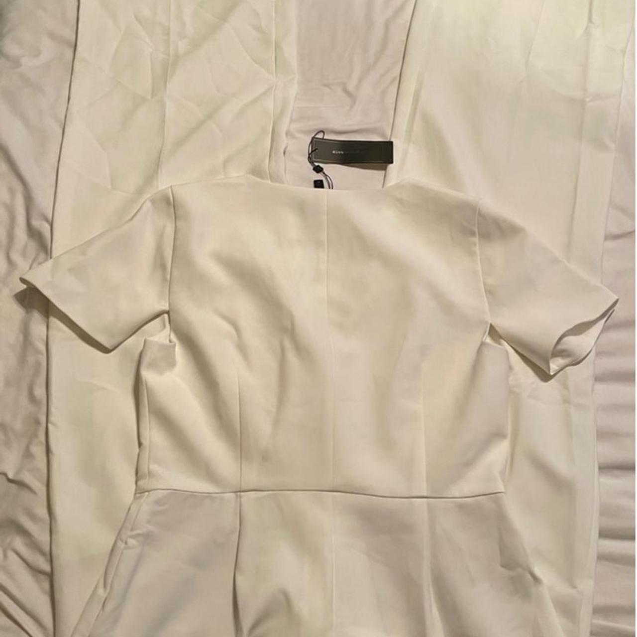 This is a white BCBGMAXAZRIA jumpsuit with a v-neck, | Depop
