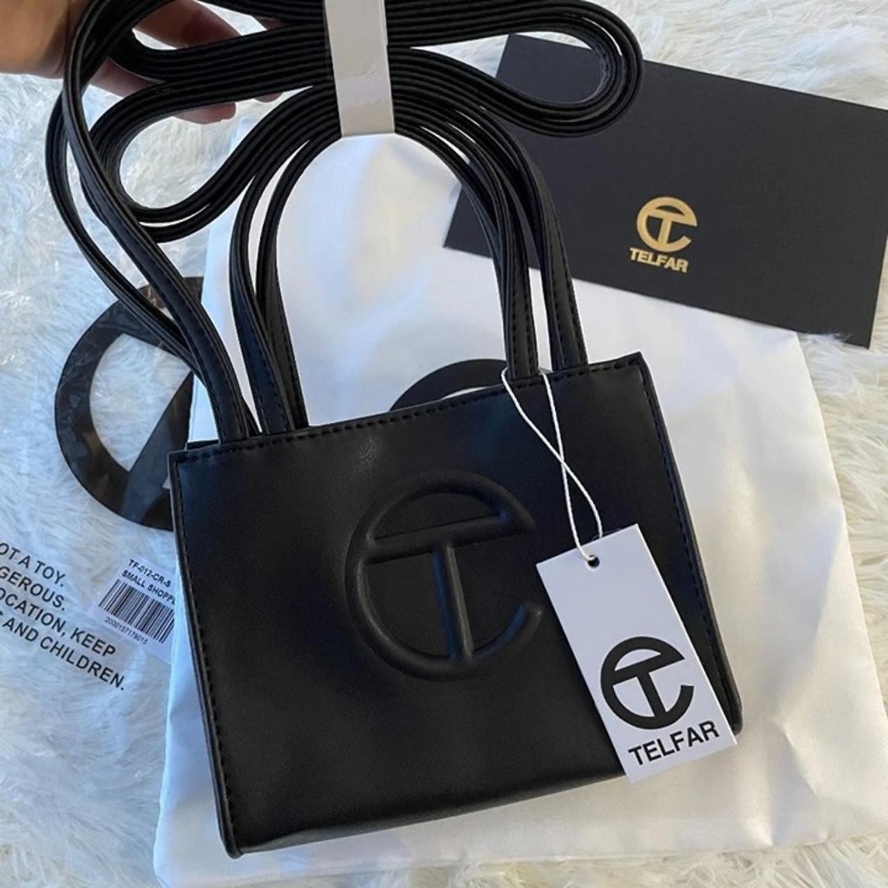 TF selling small black shopping bag