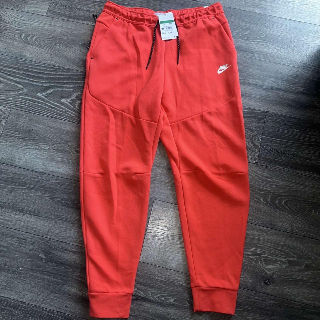 orange nike tech tracksuit