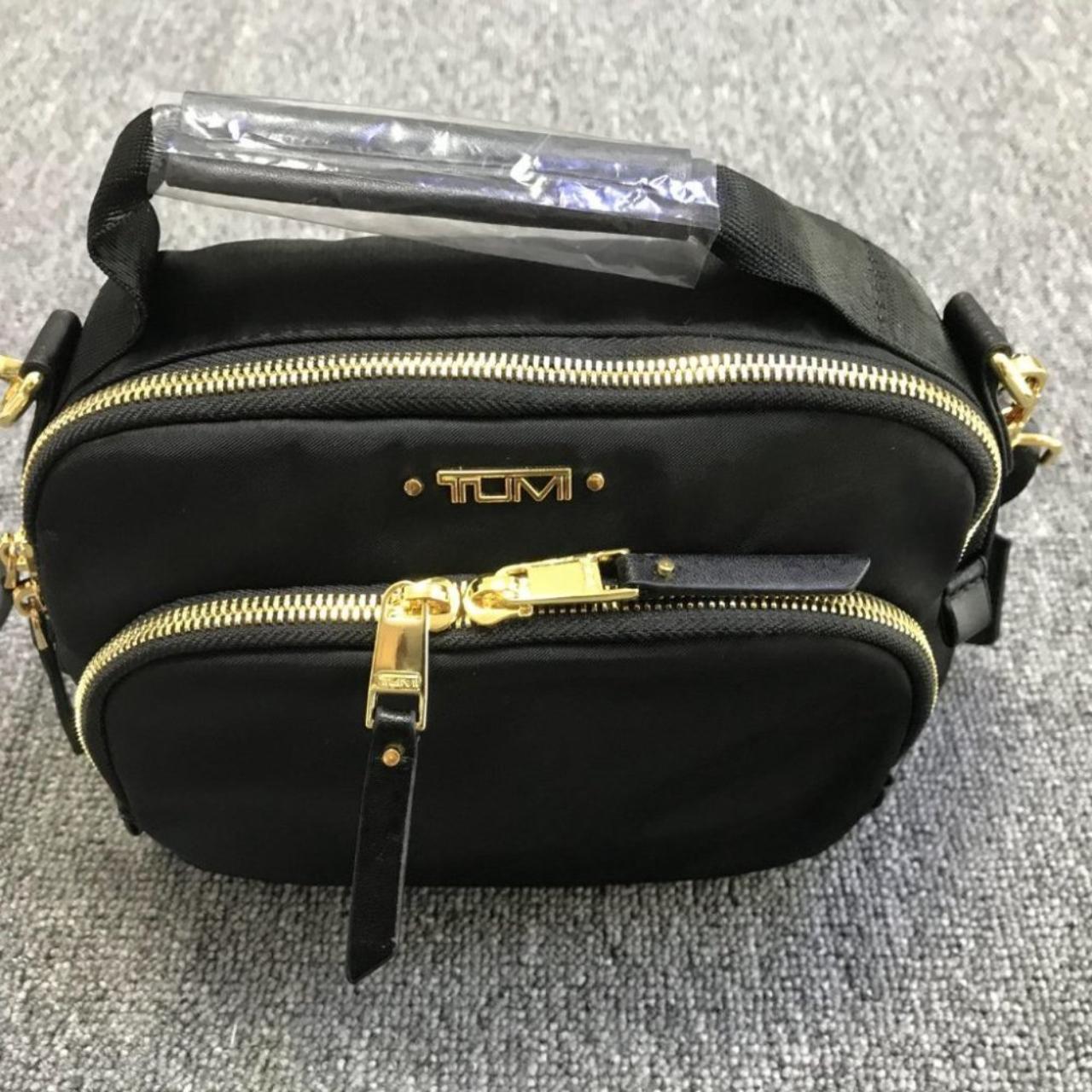 NEW Tumi Crossbody Bag NWT A zip pocket on the | Depop