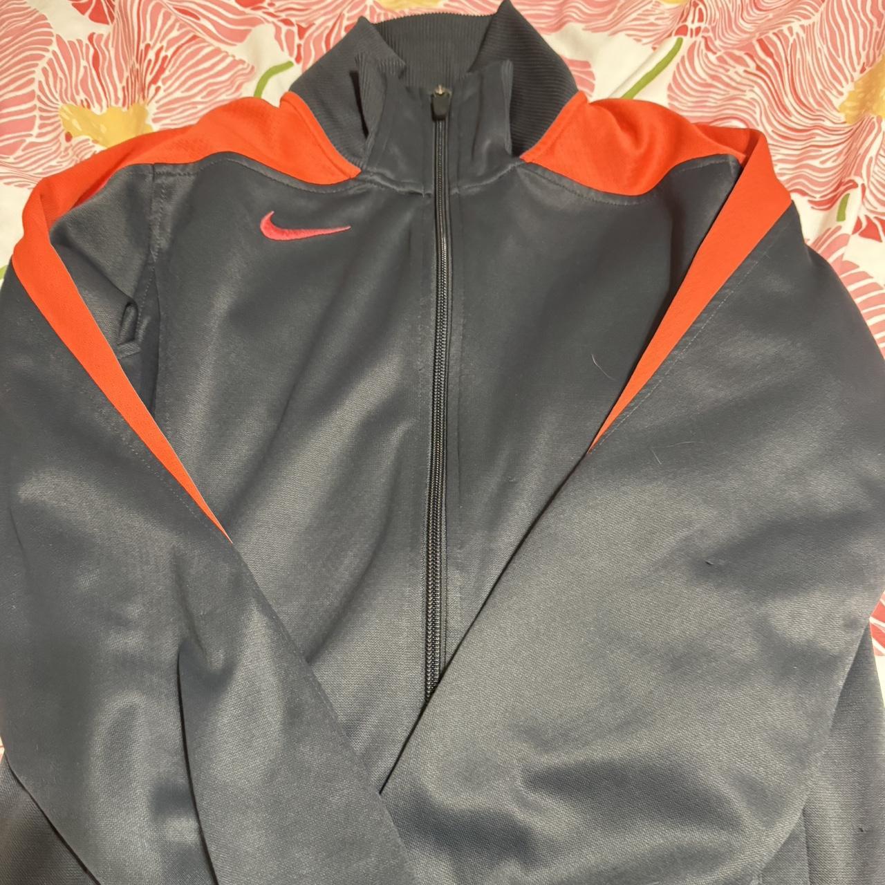 gray and orange nike zip up jacket in great. Depop