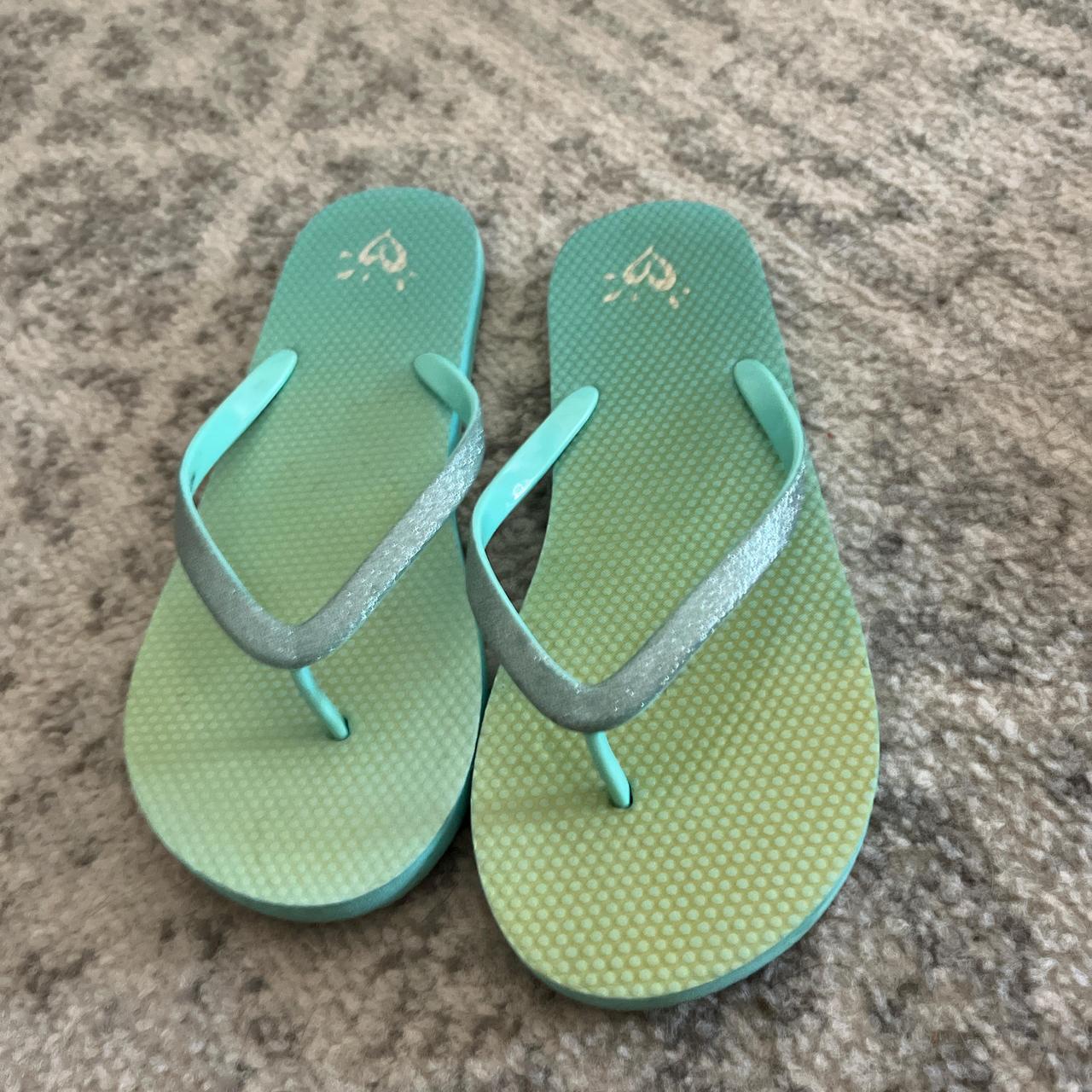 Justice flip flops color is a yellow to green ombre. Depop