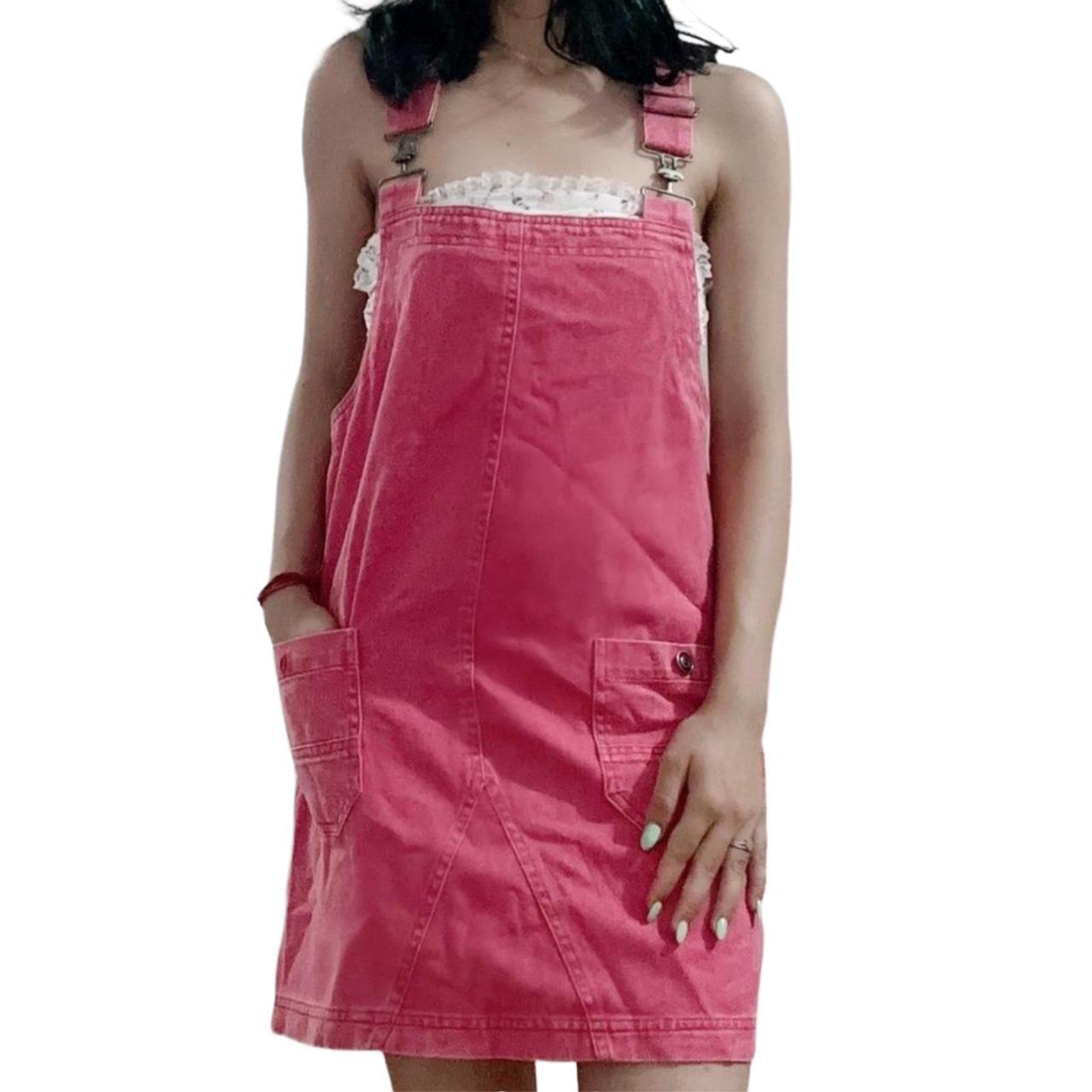 Pink denim dungaree dress with pockets will look