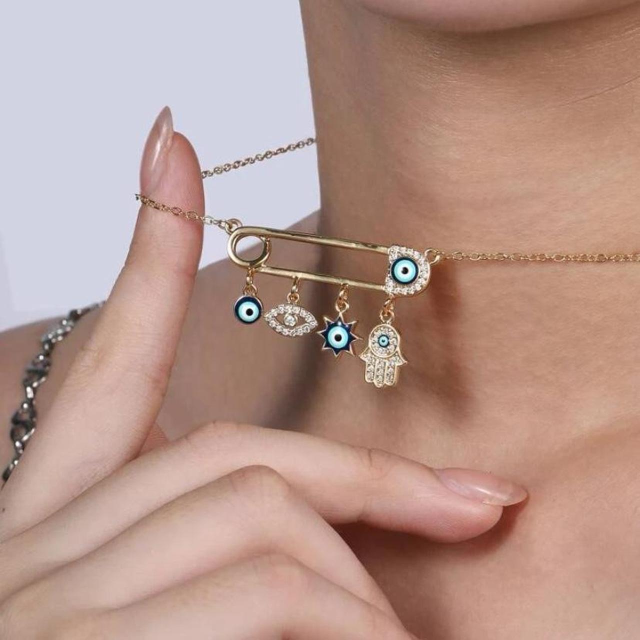 Evil eye pin necklace with a gold finish, Depop