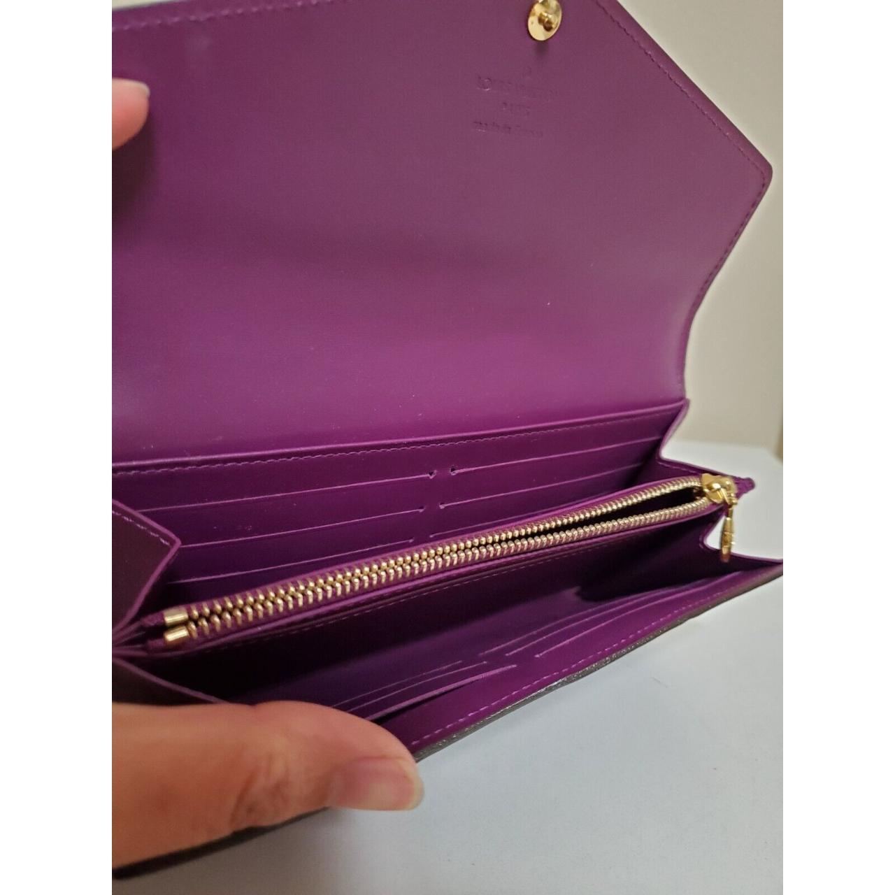 Retailer Louis Vuitton purple wallet