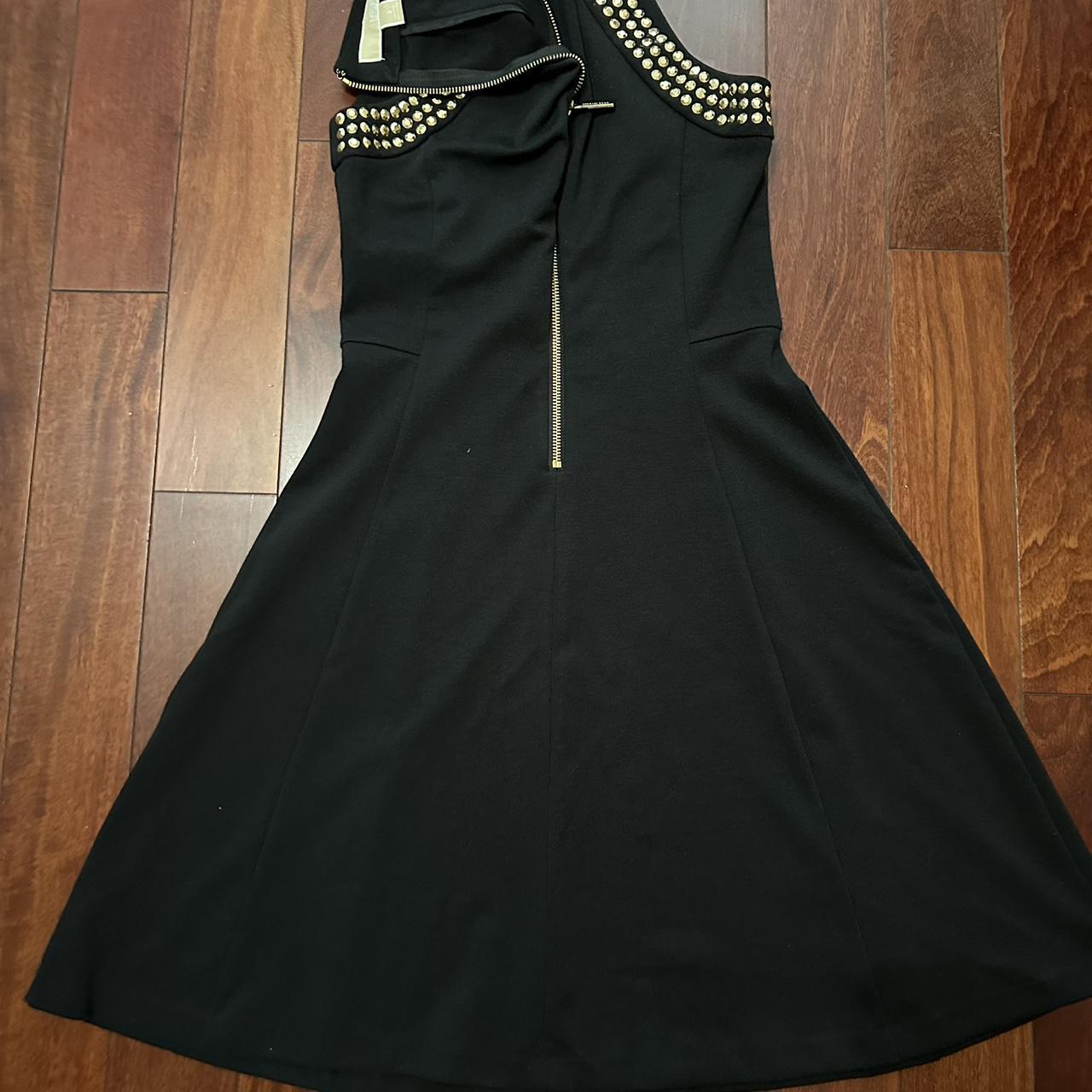 Black dress with gold studs and zipper in the