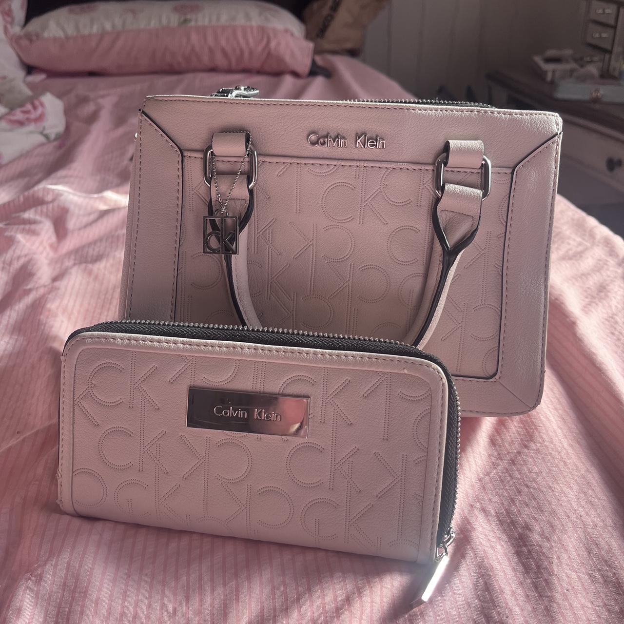 Pink Calvin Klein purse. Has three compartments and