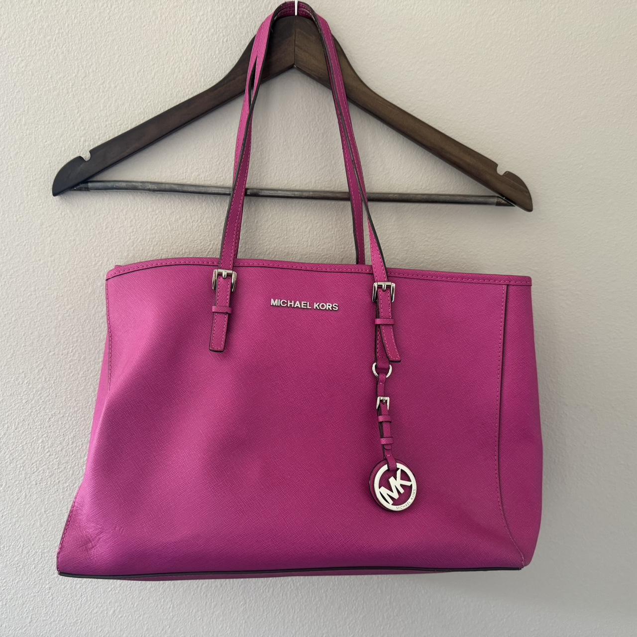 Michael Kors hot pink purse with many organizing