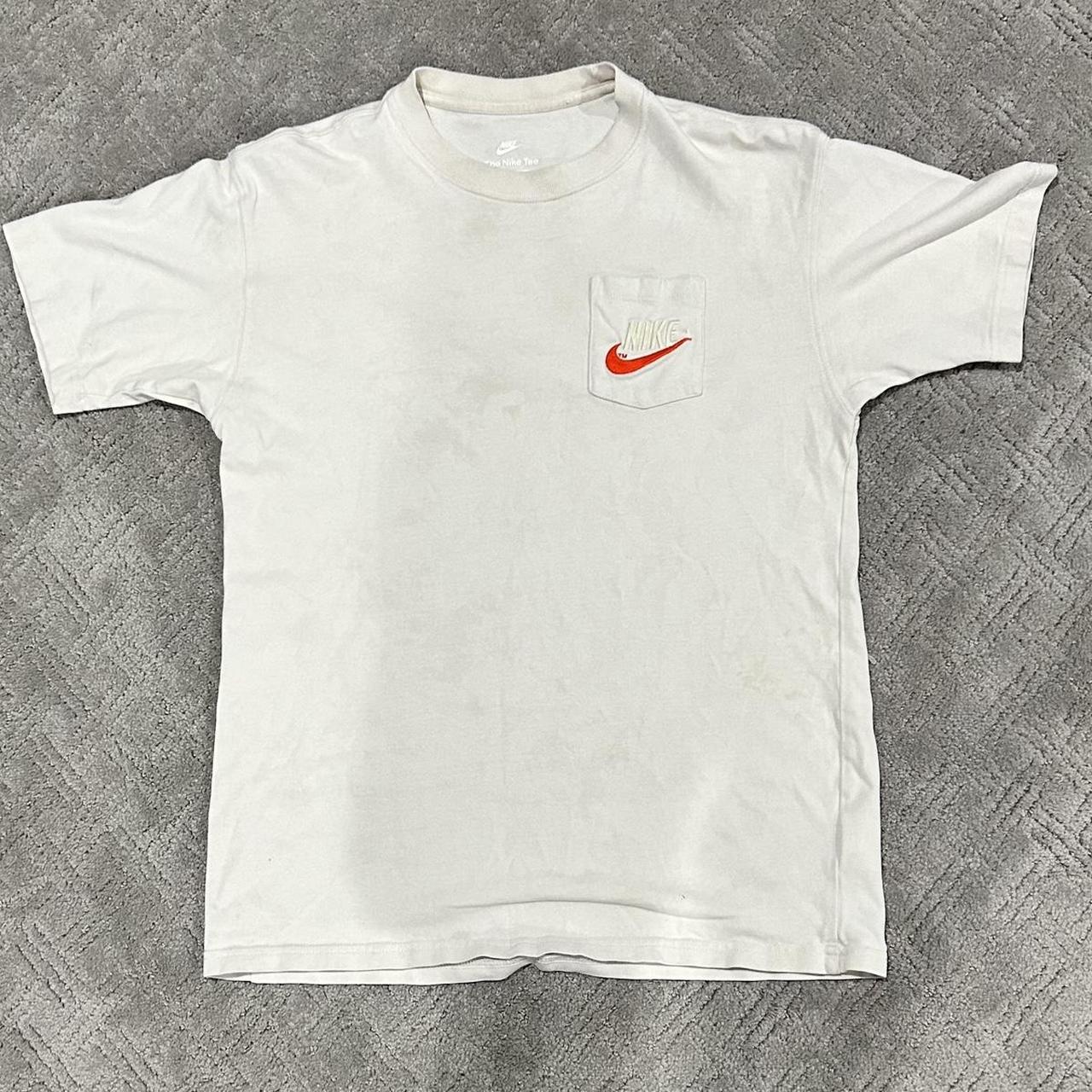 white nike shirt with red swoosh