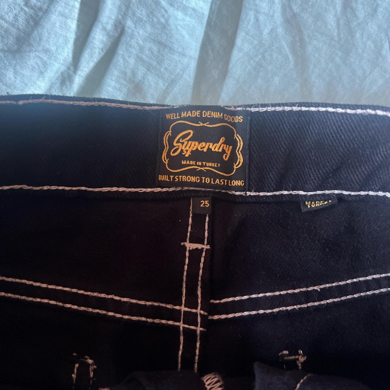 Superdry's black denim mini skirt with white... Depop