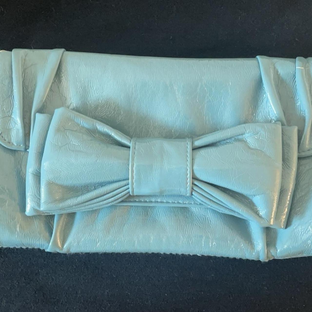 Aqua blue clutch with a bow and zipper