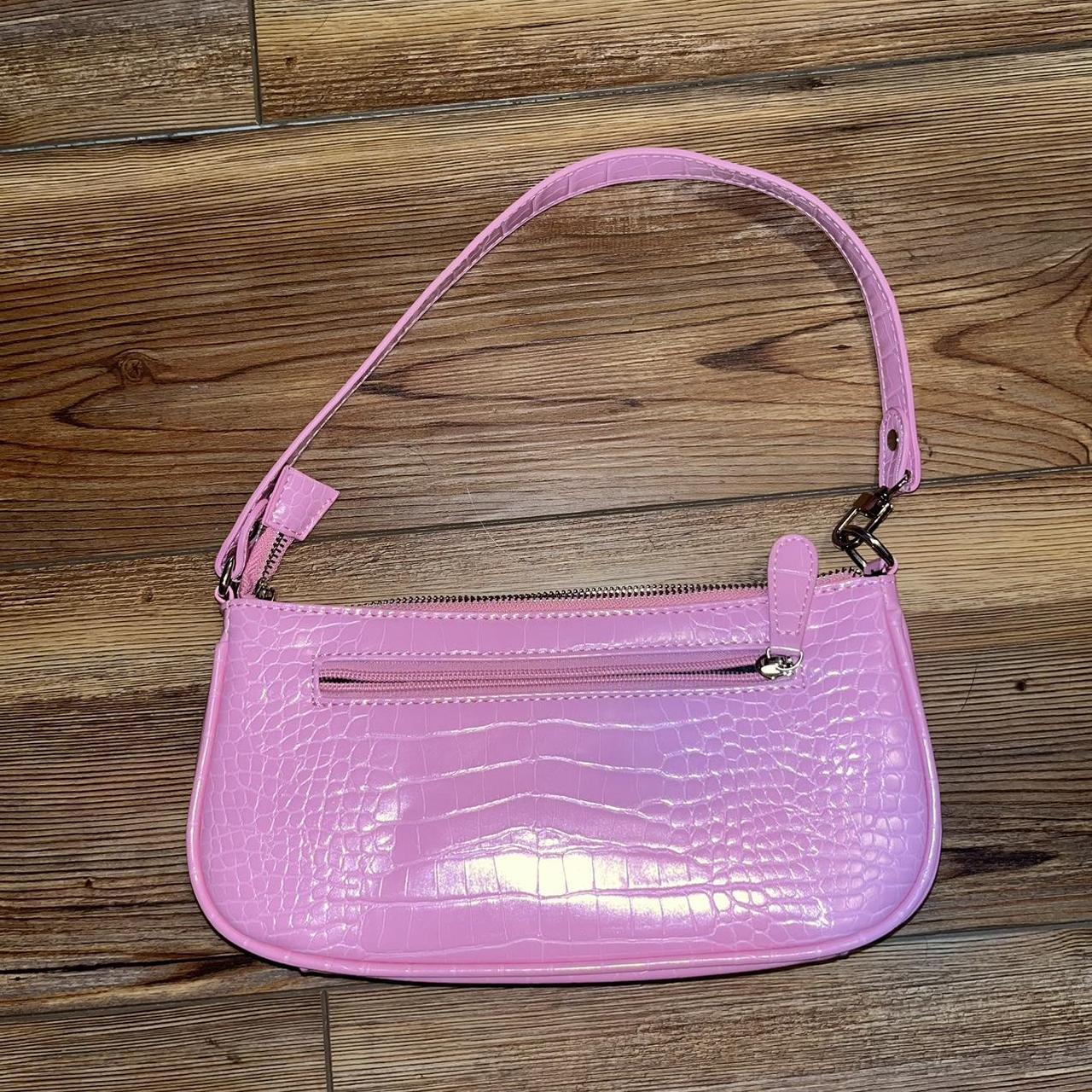 Pink shoulder bag with a small zipper pocket