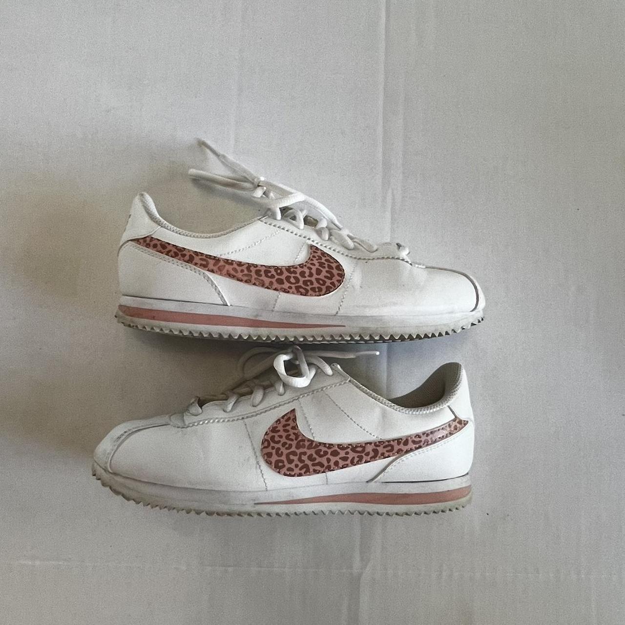 white nikes with cheetah swoosh