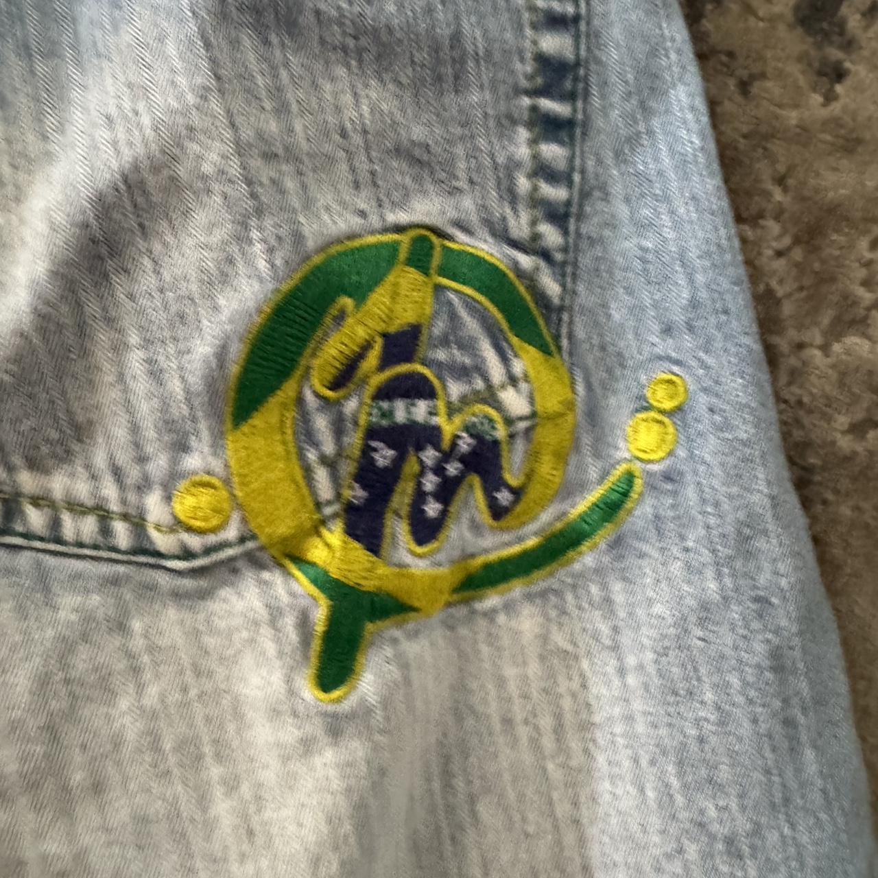 Cropped blue denim jeans with paint splatter design... Depop