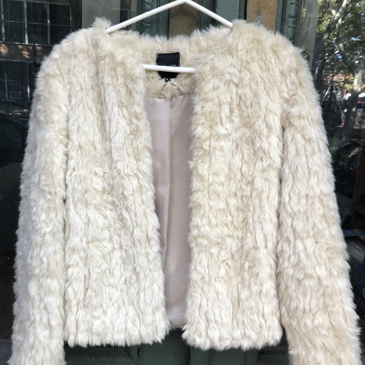 Cream faux fur jacket with warm undertones. It has a... - Depop