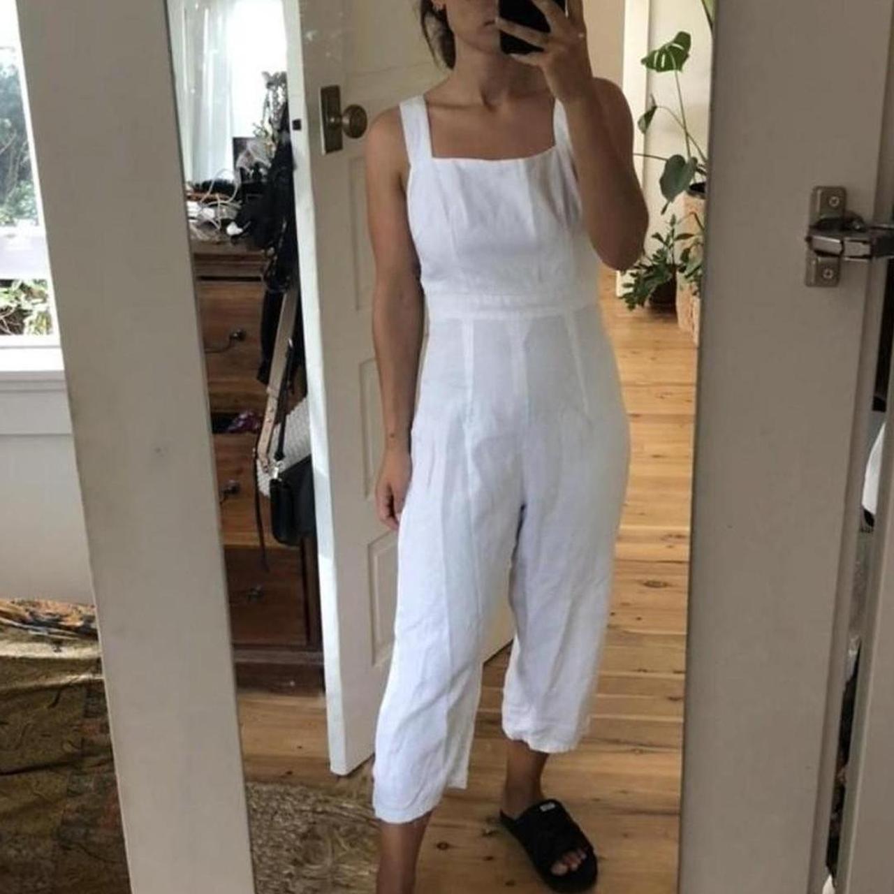 White linen jumpsuit with a square neckline and