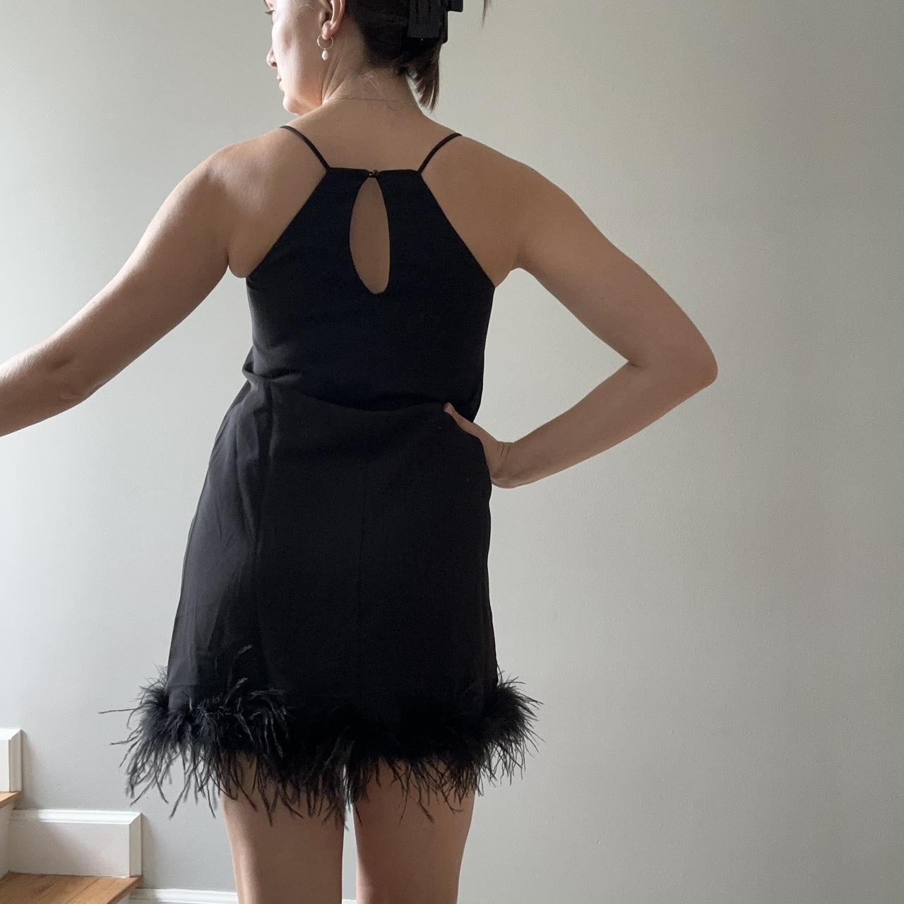 Black high neck dress with feather boa lined bottom... Depop