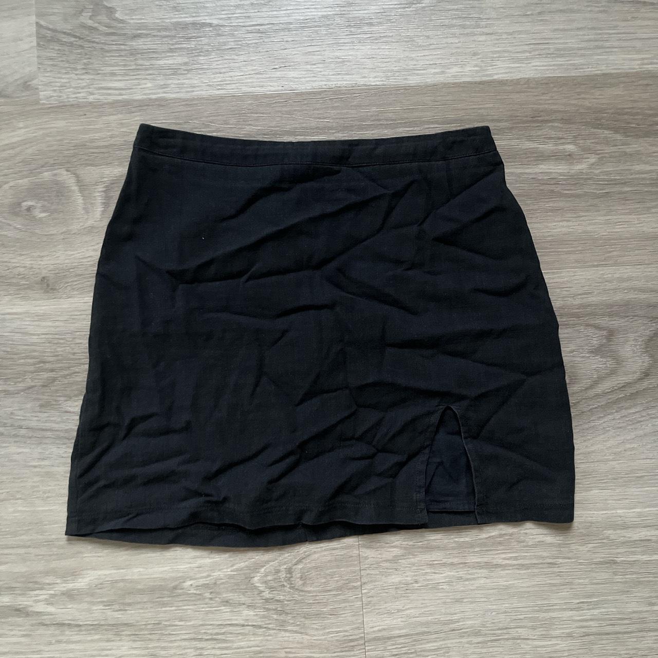 Subtitled black mini skirt with slit- Bought from... - Depop