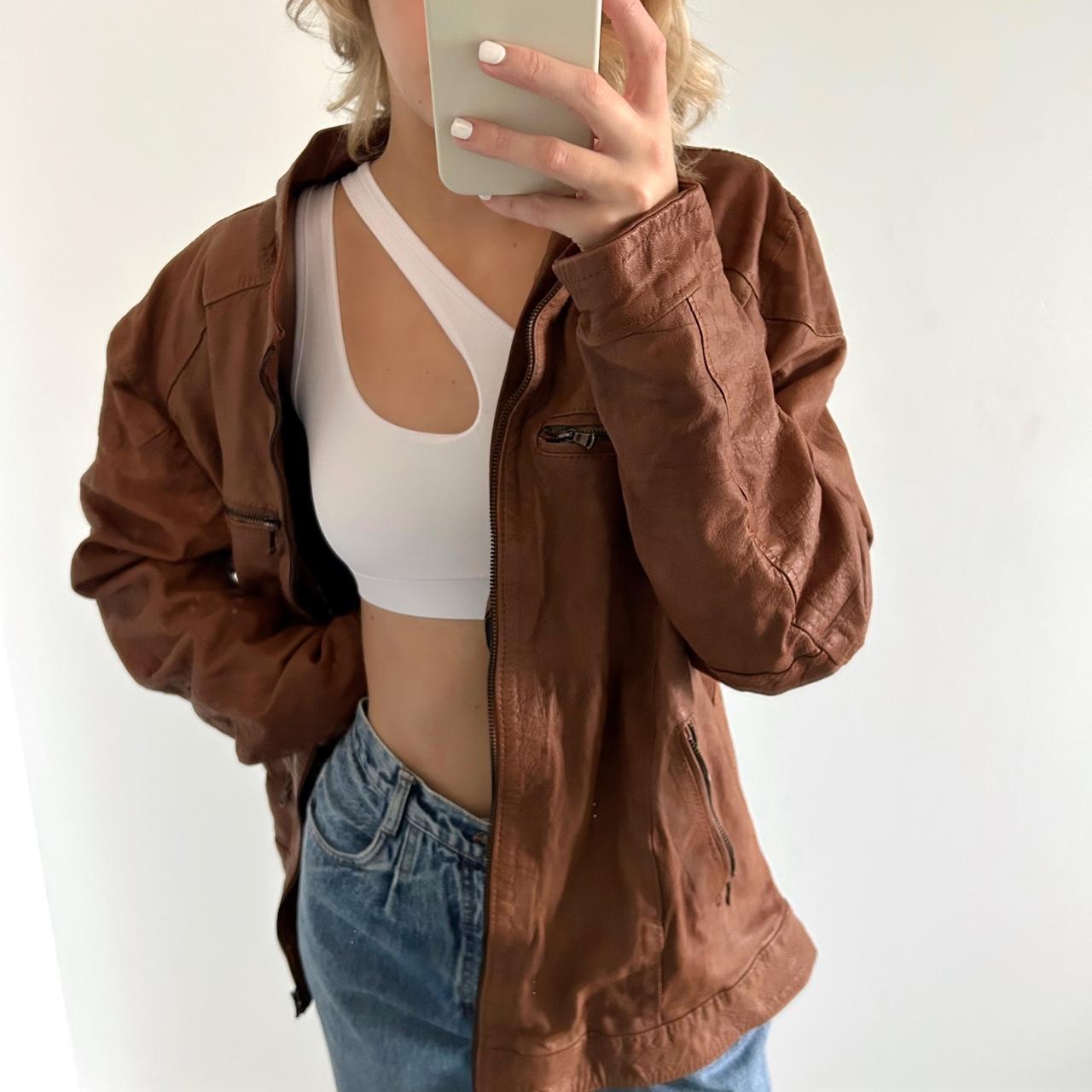 Faux leather brown jacket has a tear above the depop