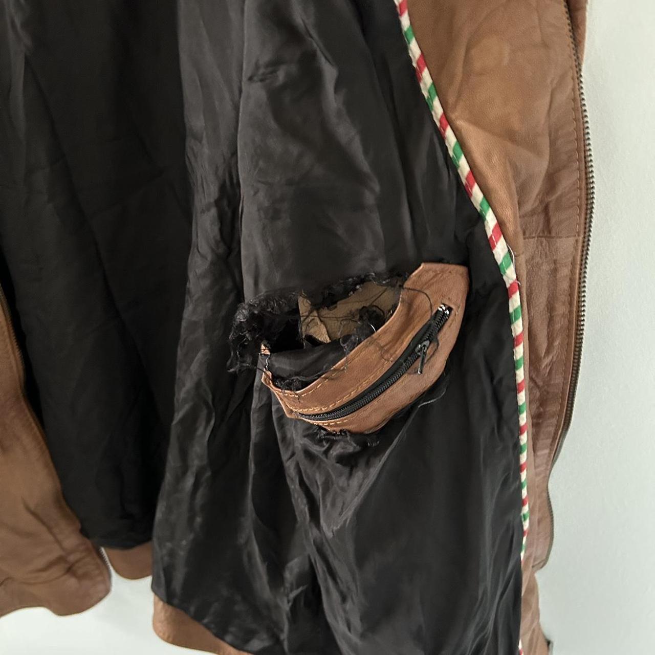 Faux leather brown jacket has a tear above the depop