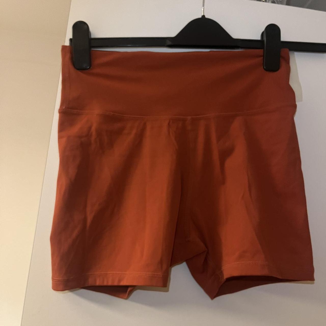 TALA orange skin luxe gym shorts with back zip - Depop