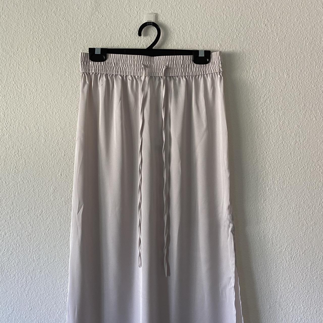 white silky and shiny maxi skirt with elastic and... - Depop