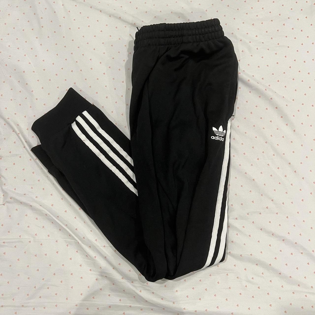 black adidas sweatpants with the classic 3 stripes... Depop