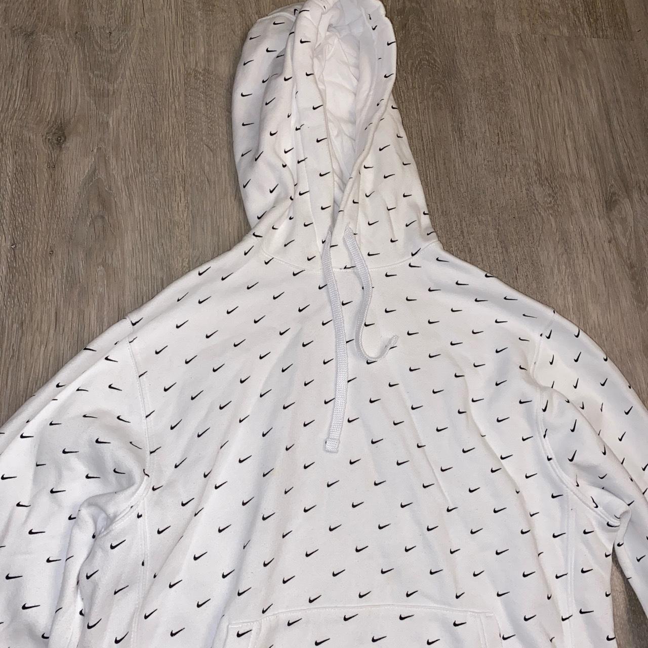 white nike jumper with black ticks all over