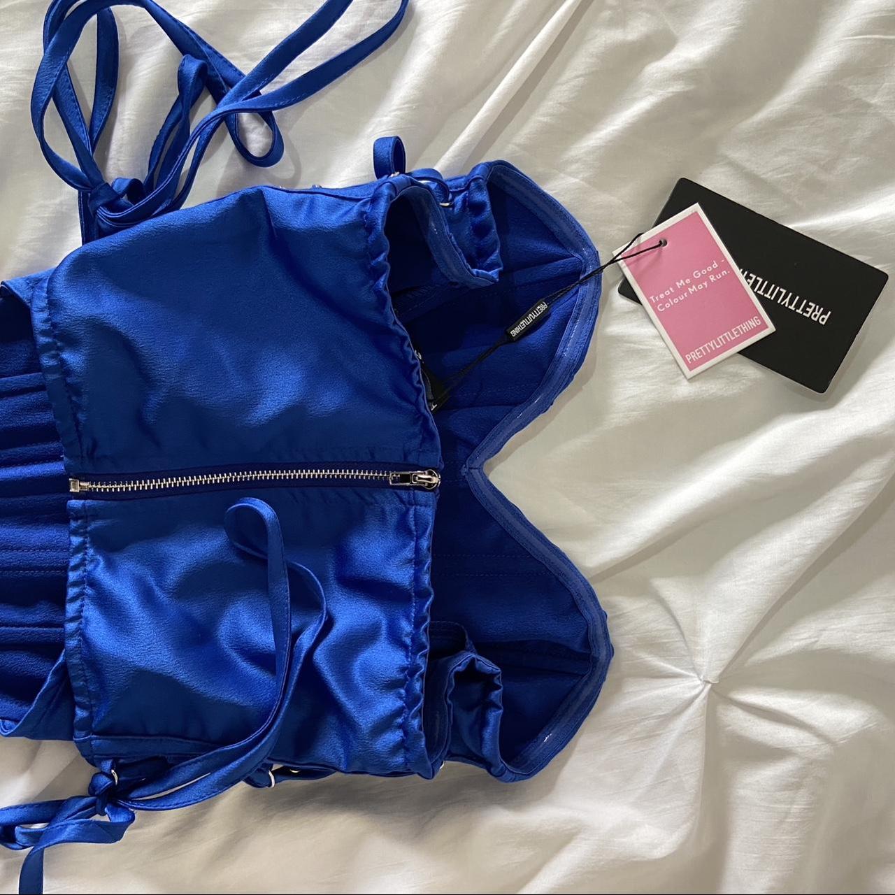 Blue satin strapless corset top. Boned structure and... Depop