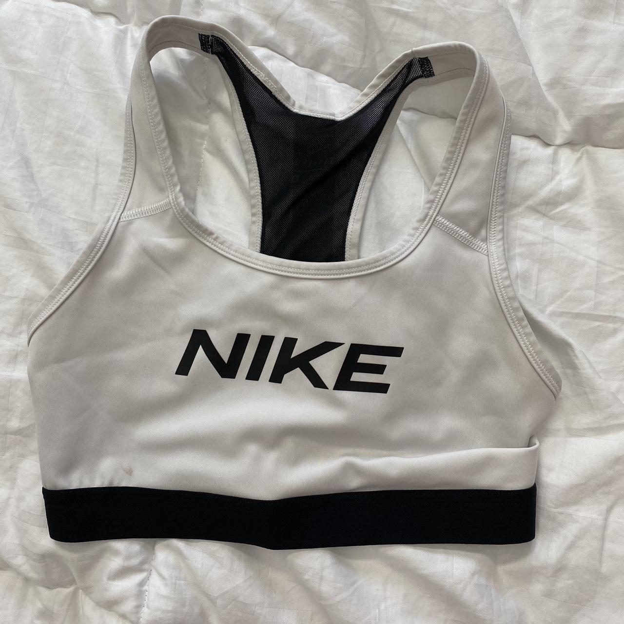 Nike sports bra. Has a tiny stain on the front but I... - Depop