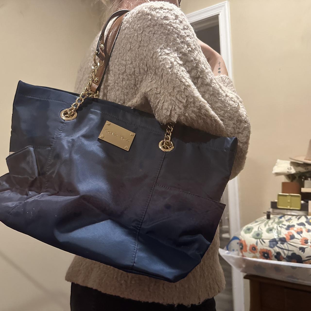 Large navy blue Calvin Klein purse. Has pockets on