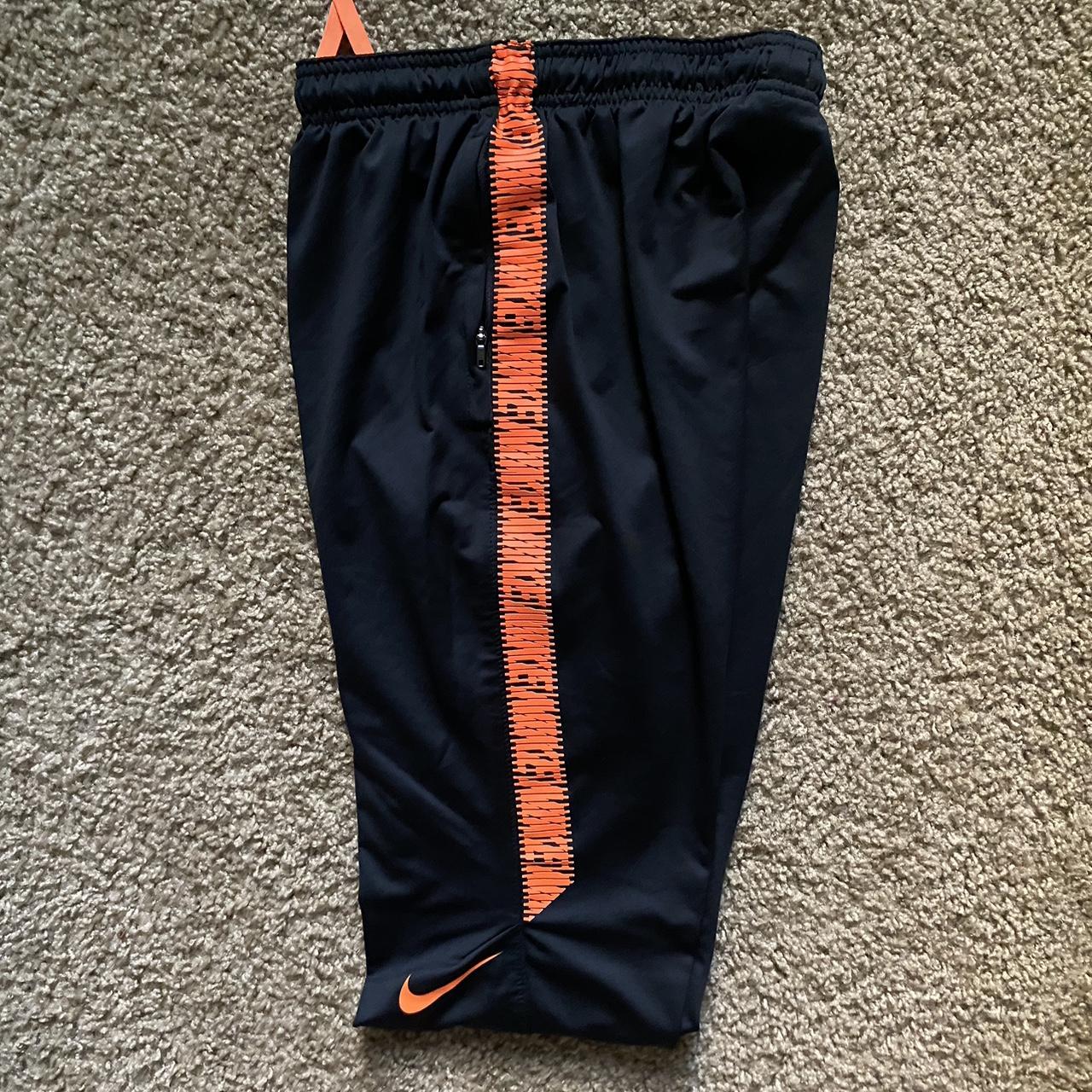 Black and best sale orange nike pants