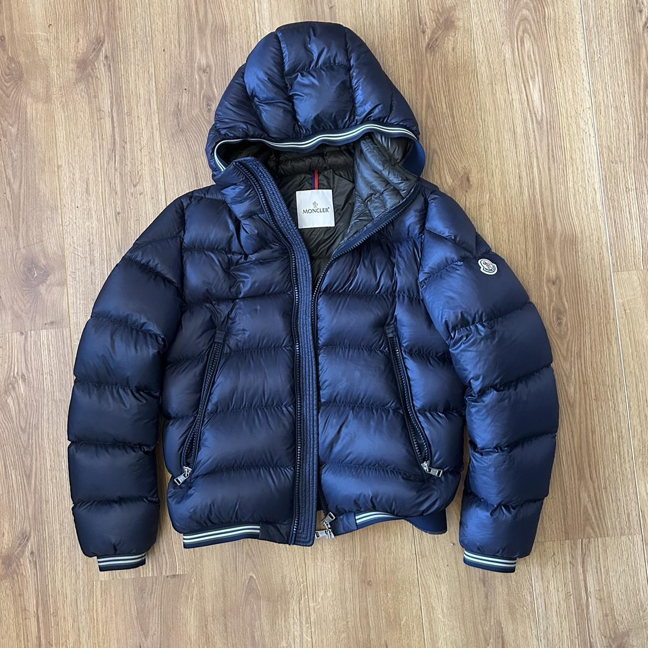 Worn navy Moncler coat, has a small hole in the... - Depop