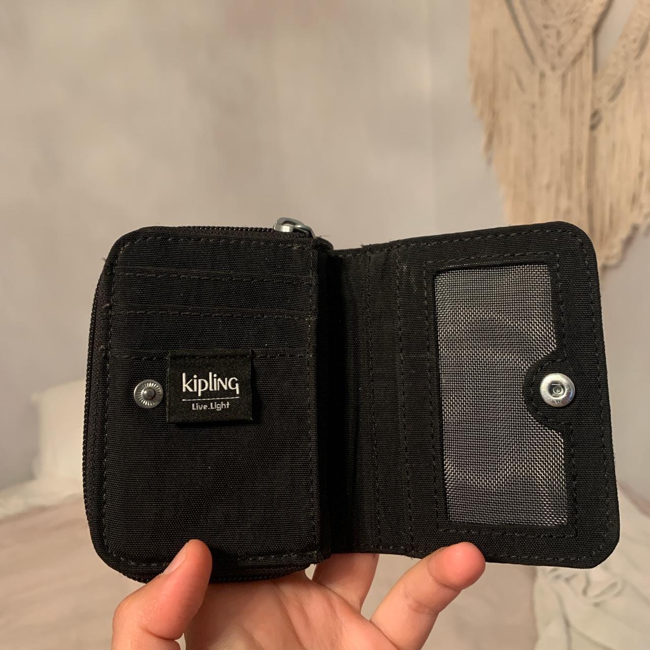 Kipling wallet in black. It has four compartments in... Depop