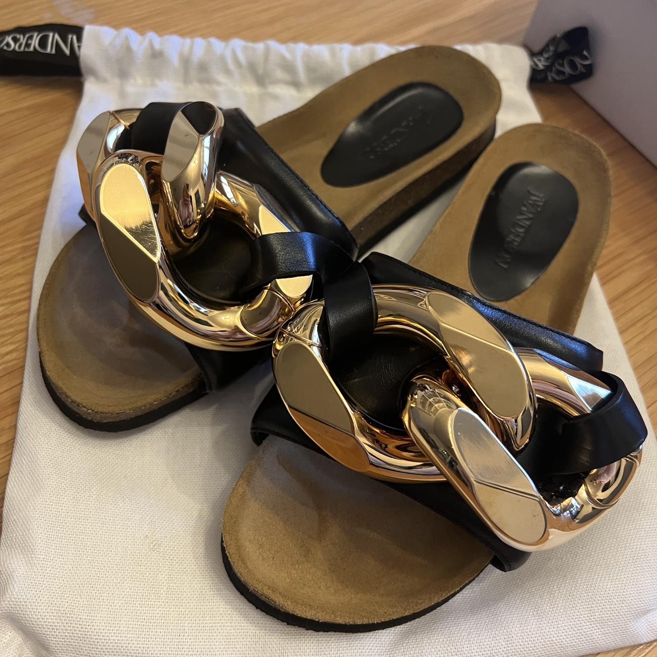 JW Anderson Women's Black and Gold Slides | Depop