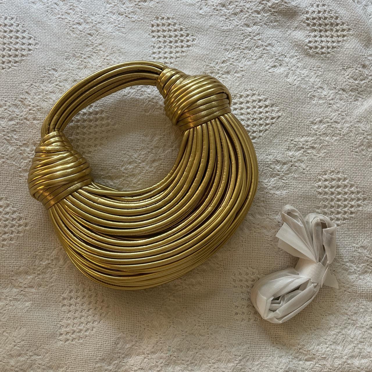 gold bottega style knot bag. comes with strap. used... Depop