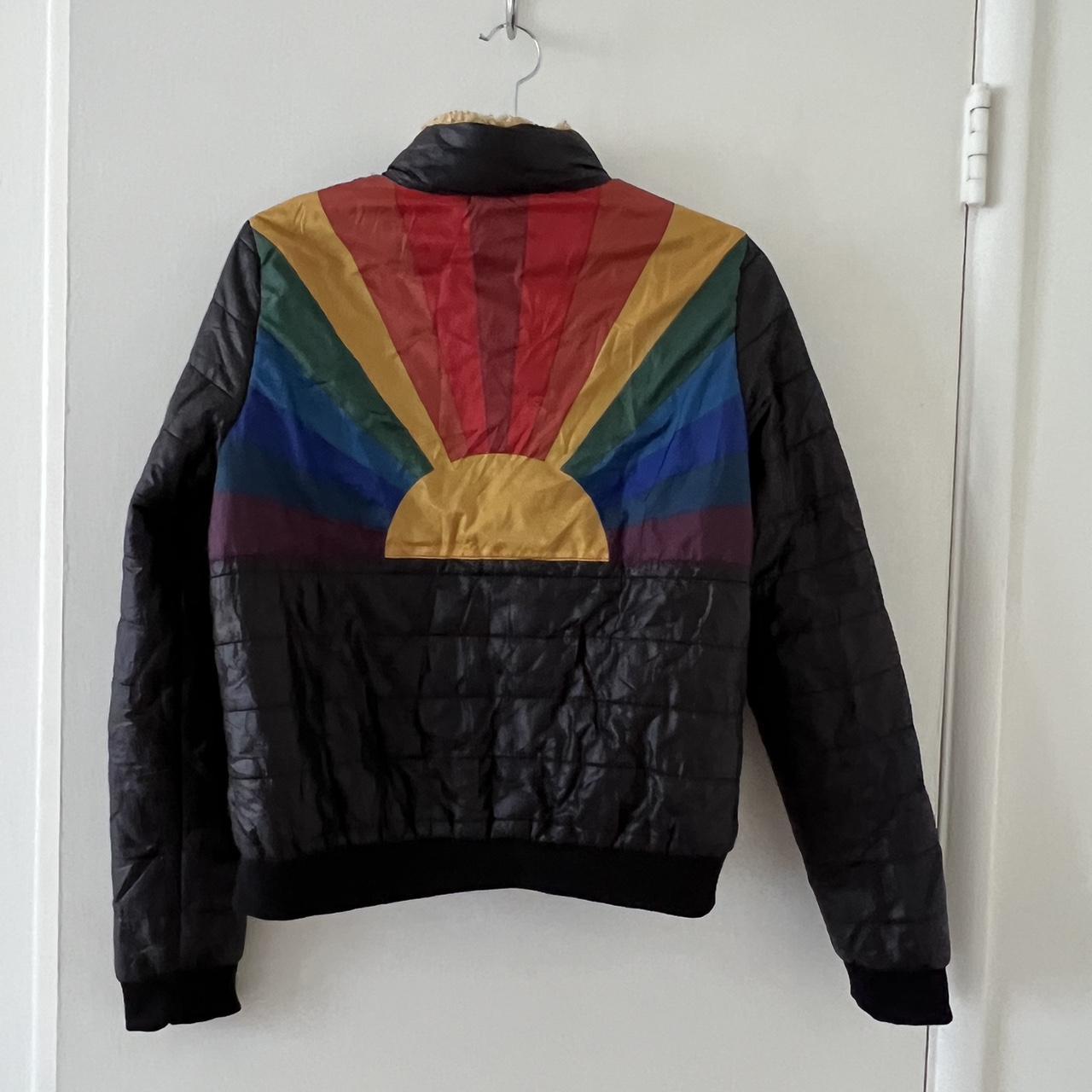 Black puffer jacket with with rainbow sunrise on back