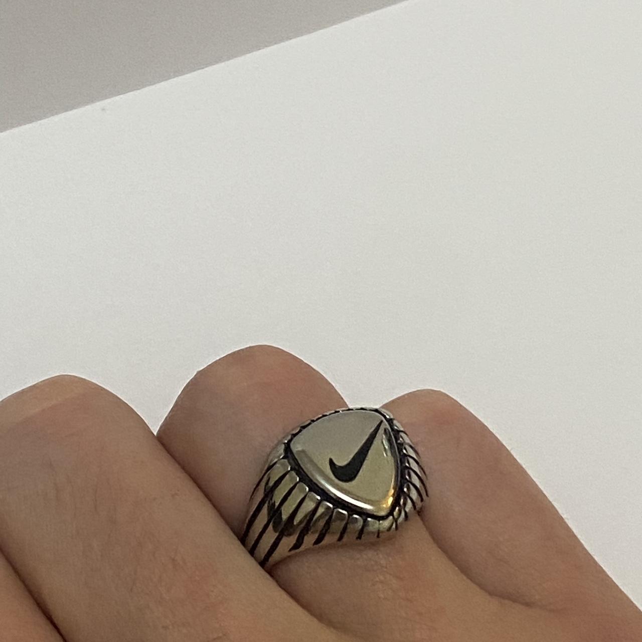Silver and Black Nike Ring. Wearing a size 8... Depop