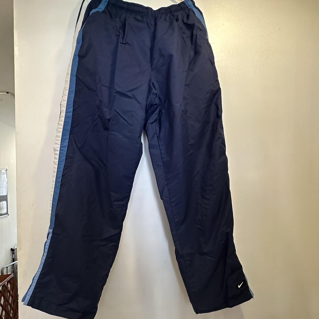 blue Nike track bottoms size M would best fit size... - Depop