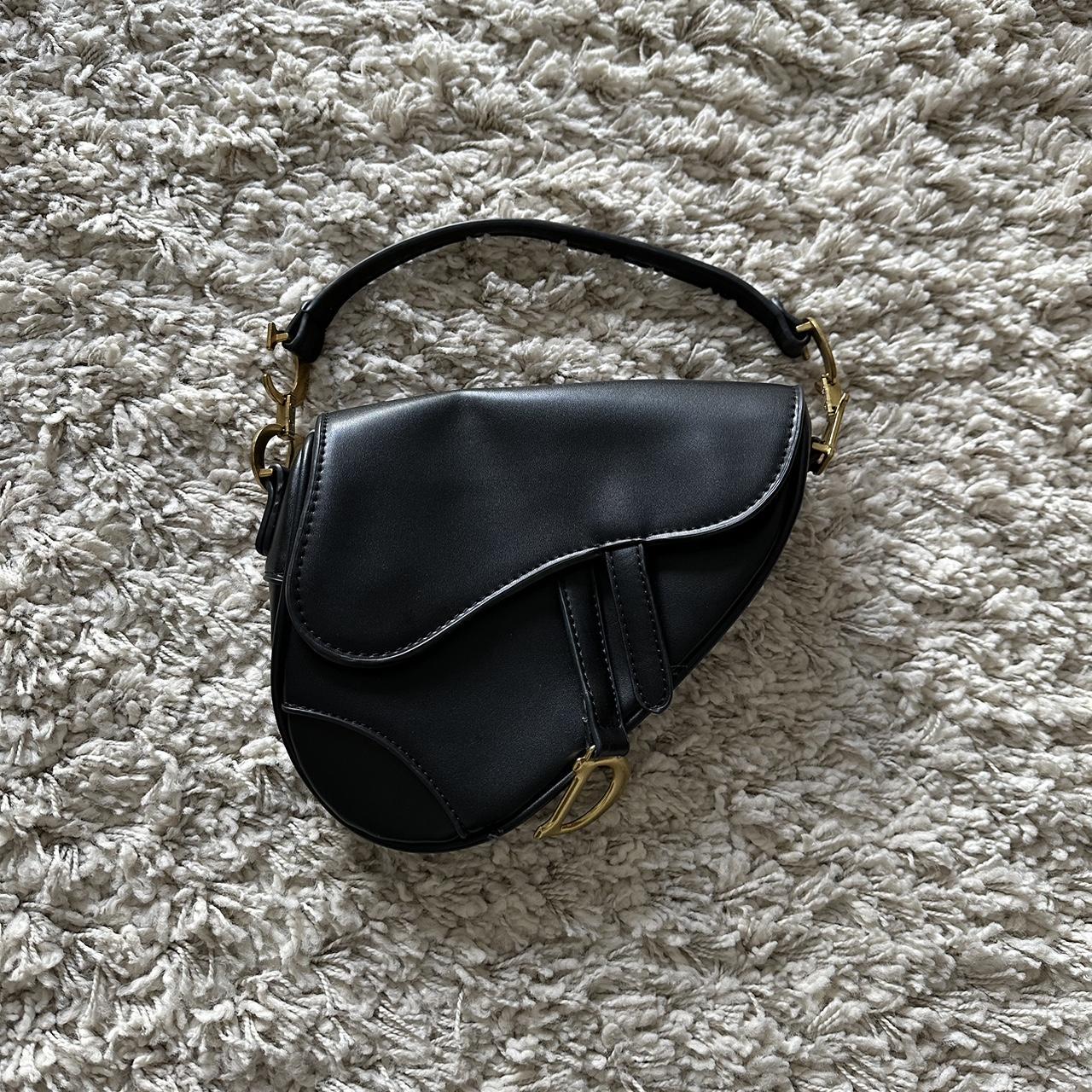 Black saddle bag with gold detailing Used a lot... - Depop