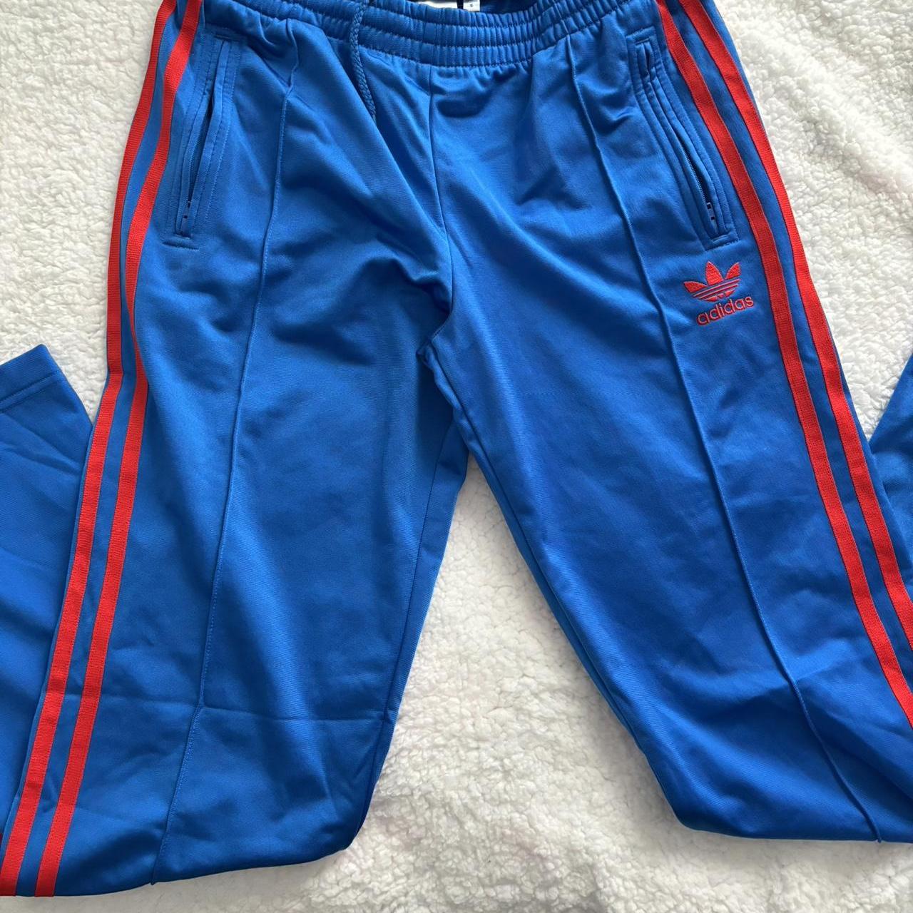 90s Adidas blue and red trackies. With zippers as... - Depop