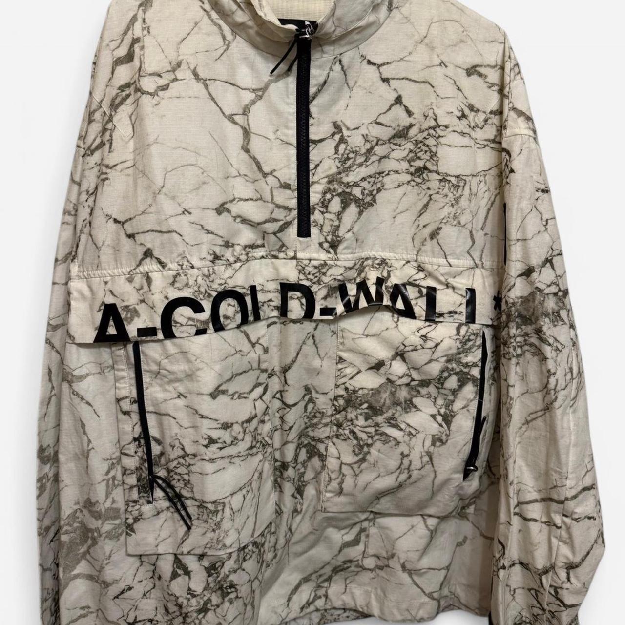 cream and black coldwall soft shellwindbreaker